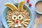 Funny hare - porridge with berries for breakfast. Â  Children`s breakfast.